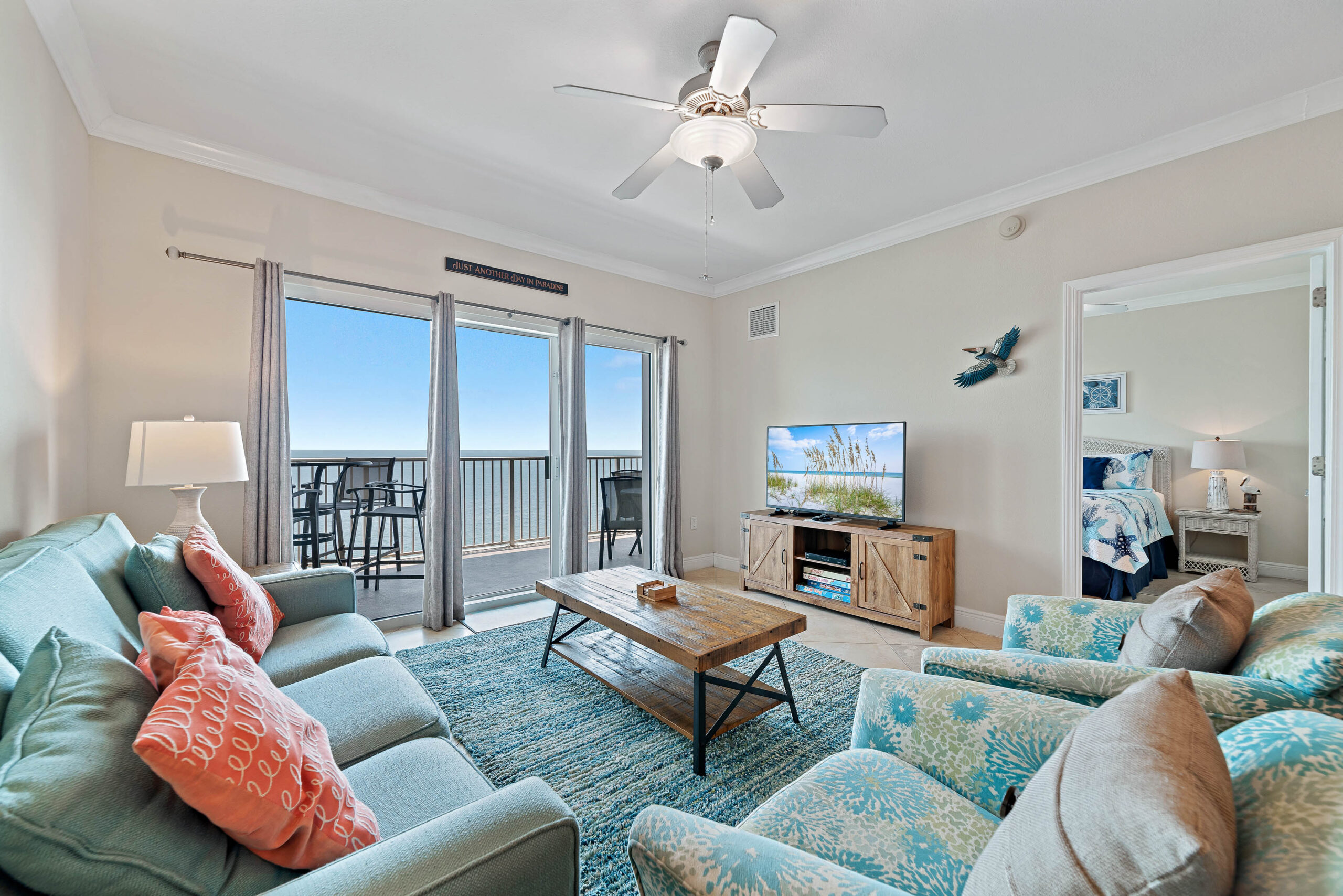 Open living and dining area with ocean views and balcony access at Salty Air Retreat
